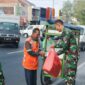 Prajurit Yonarmed 1 Kostrad melaksanakan berbagi kepada masyarakat di sekitar Jalan Singosari, Malang, Jumat (18/07/2025). (foto: Penajusta/Narwan) 